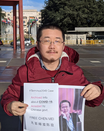 Chen Kun holds a picture of his brother in front of the United Nations building in Geneva