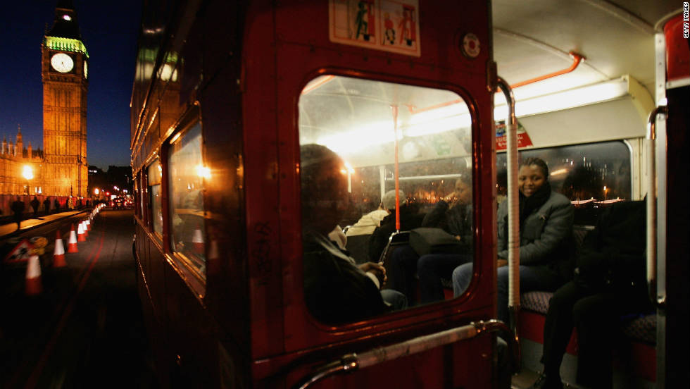 Passengers inside an old Routemaster, as seen from the open platform at the rear. 