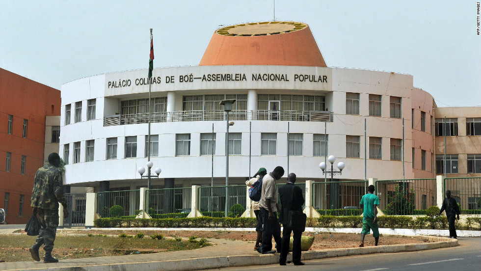 Residents walk past the Parliament in Bissau, capital of Guinea-Bissau. African countries rank as at high risk in the index, partly due to their natural susceptibility to events such as floods, droughts, fires, storms or landslides. But their high ranking is also a product of the vulnerability of the population and the inadequacies of existing infrastructure to adapt to or tackle climate change challenges because of weak economies, governance, education and health care.