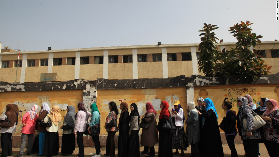Egyptian women wait outside a polling station in Cairo. Many Egyptians seem uncertain of their loyalties to any particular candidate.