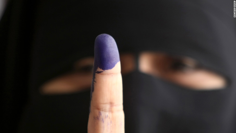 An Egyptian woman holds up an ink-stained finger after casting her ballot in Cairo on Wednesday, May 23, the first day of voting in the historic election. 