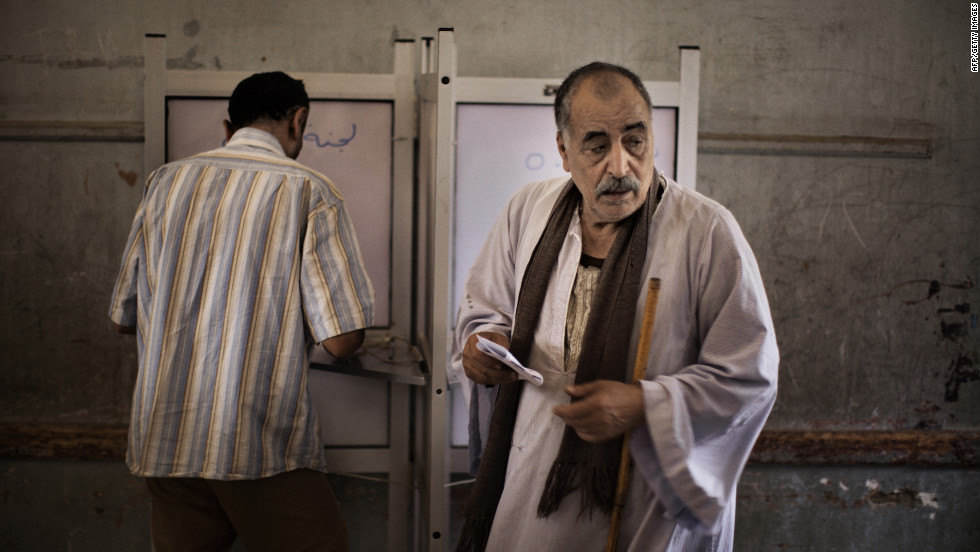 Egyptian men fill out their ballots at a Cairo polling place.