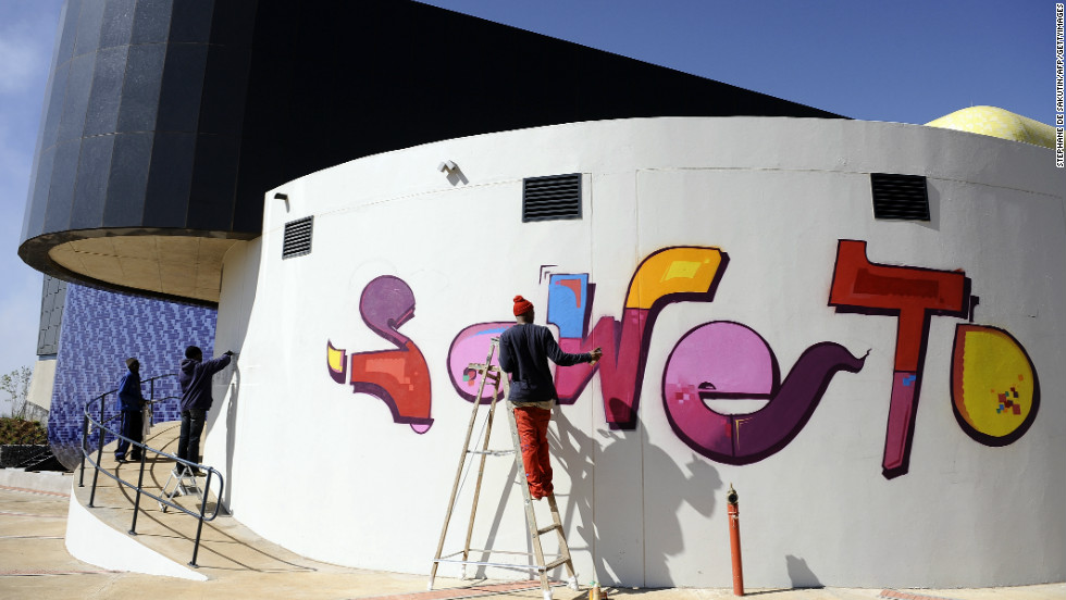 Laborers finish the paintwork on the newly inaugurated Soweto Theater, a powerful symbol of the Johannesburg&#39;s rebirth.