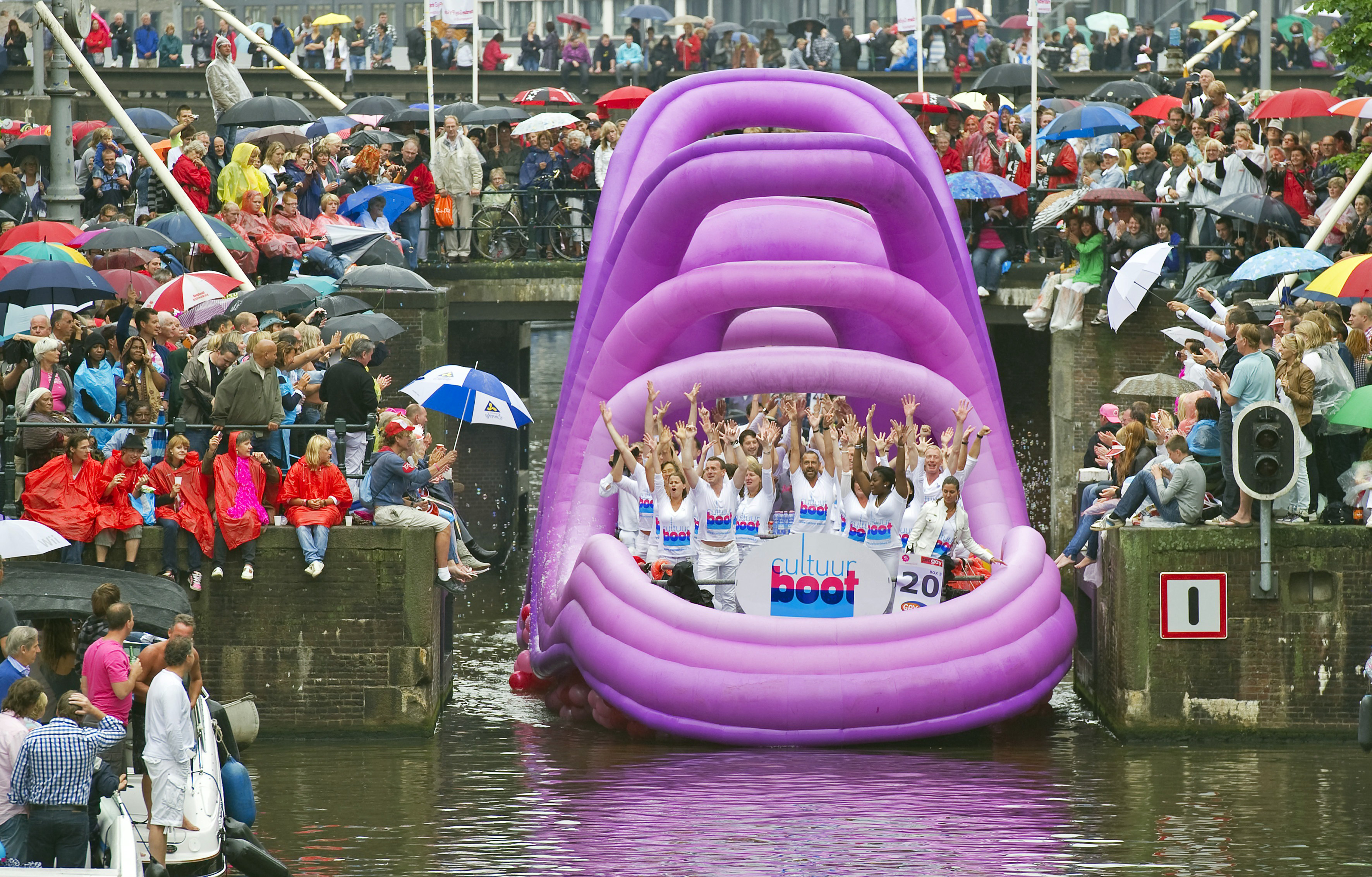 Patricipants in Amsterdam's annual Canal Pride wave to crowds. 