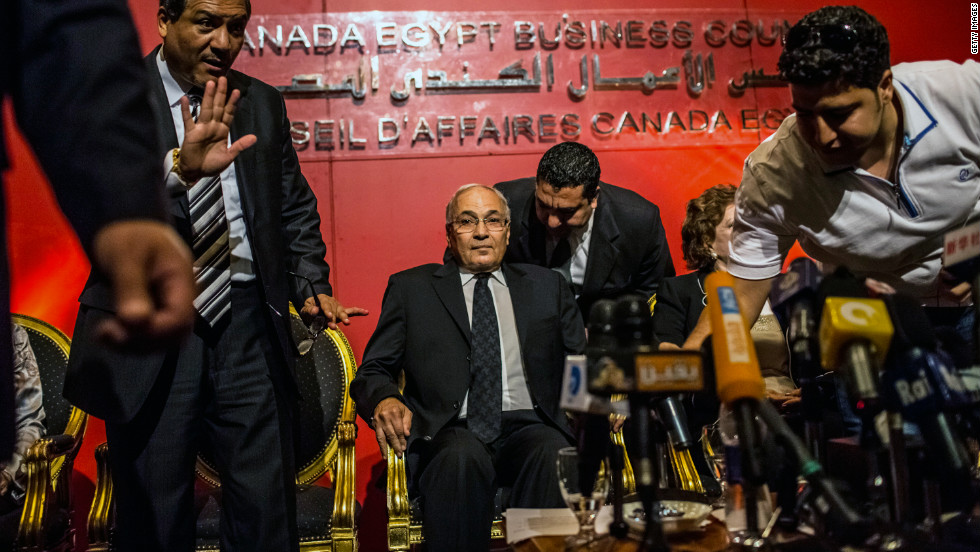 Former Prime Minister Ahmed Shafiq, center, is seated before addressing a business conference in Cairo on Wednesday.