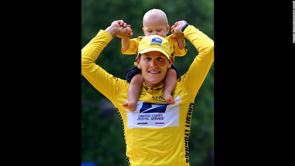 After winning the 2000 Tour de France, Armstrong holds his son Luke on his shoulders.
