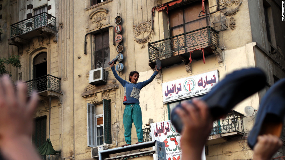 An Egyptian boy waves his shoes as he joins supporters of the Muslim Brotherhood in a protest in Cairo&#39;s Tahrir Square against Mubarak-era prime minister and presidential candidate Ahmed Shafik after Egypt&#39;s top court rejected on Thursday a law barring him from standing in a tense presidential poll runoff.