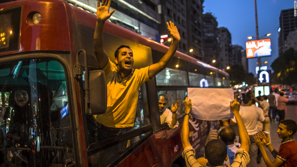 A bus driver stops to wave in support of Egyptian protesters making their way to Tahrir Square on Thursday.