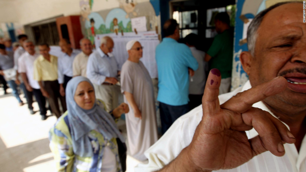 An Egyptian man shows off his little finger covered in indelible ink after casting his vote at a polling station in Cairo.