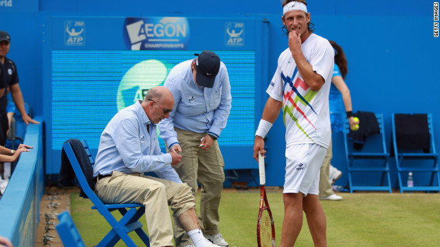 David Nalbandian is next to lineman Andrew McDougall, whose leg was injured during the incident at Queen's Club. 