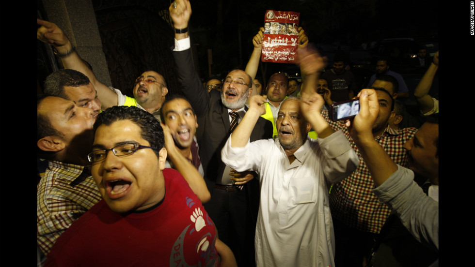 Morsi supporters celebrate Monday in Cairo. Votes in the Egyptian capital, the largest population center, continued to be tallied, but unofficial results by a state-run news website showed Morsi leading elsewhere with 11.2 million votes, compared with 10.3 million for Ahmed Shafik, the last prime minister in the waning days of Mubarak&#39;s regime.