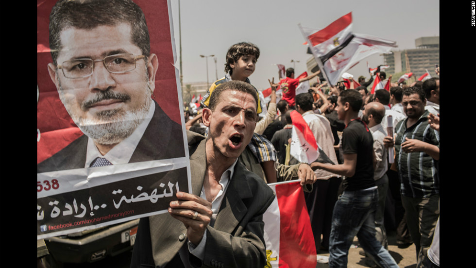 Morsi supporters rally in Cairo&#39;s Tahrir Square on Monday, June 18. Morsi declared victory as Egypt&#39;s first democratically elected president even as military rulers issued a decree that virtually stripped the position of power.