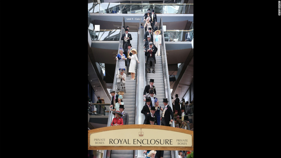 Race-goers ride an escalator down from the private boxes of the Royal Enclosure.