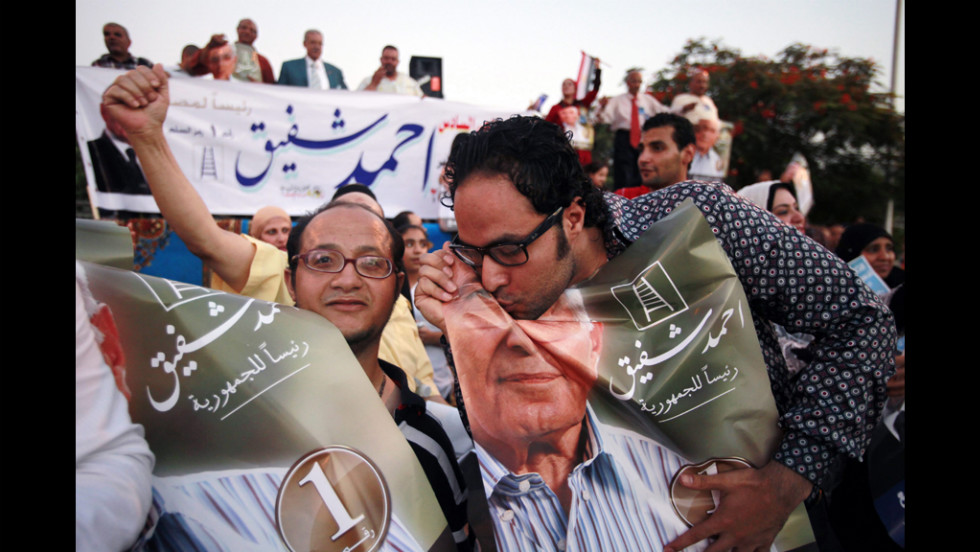 A supporter of Egyptian presidential candidate Ahmed Shafik kisses a portrait of him during a Cairo rally Wednesday, June 20. Shafik was the last prime minister to serve under Hosni Mubarak