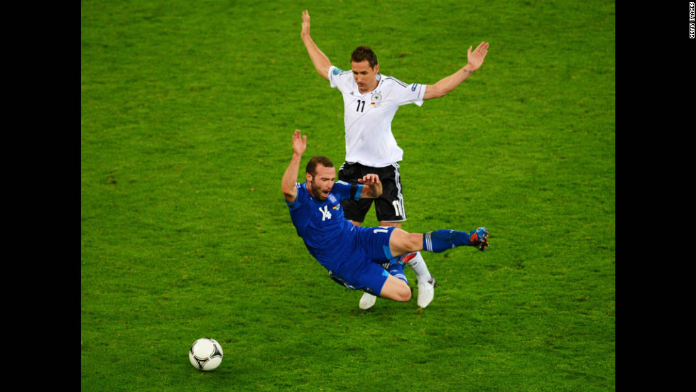 Germany's Miroslav Klose clashes with Greece's Dimitris Salpigidis.