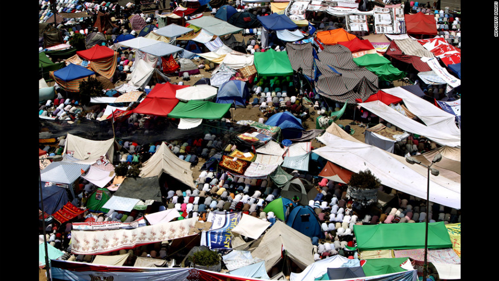 Protesters perform Friday noon prayer under tents erected in Cairo&#39;s landmark Tahrir Square.