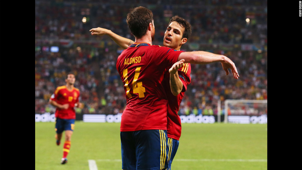 Xabi Alonso of Spain celebrates after scoring the first goal with Cesc Fabregas during Spain's quarterfinal match against France.