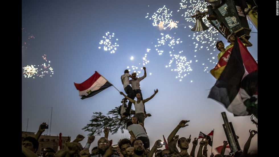 As fireworks burst overhead, Egyptians in Tahrir Square celebrate Mohamed Morsi&#39;s election on Sunday.