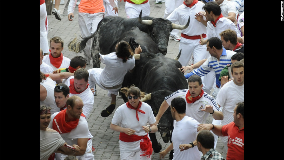 People try to escape the horns and hooves of the bulls on Saturday.