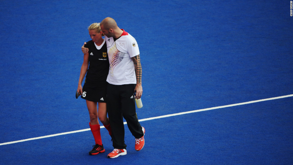 Fanny Rinne of Germany is consoled as she walks off the field after the women's field hockey match with New Zealand ended in a draw.