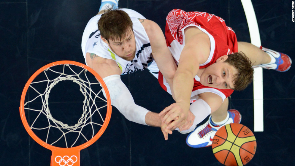Argentinian forward Andres Nocioni, left, challenges Russian center Timofey Mozgov during the men's bronze medal basketball game at the North Greenwich Arena. Russia won 81-77.