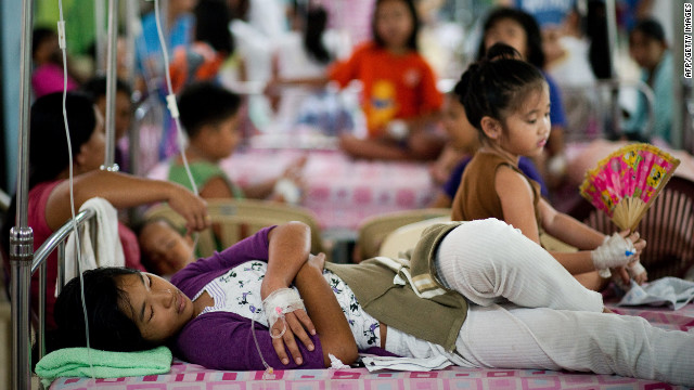 Filipinos infected with dengue sleep on beds at Quirino hospital in Manila.