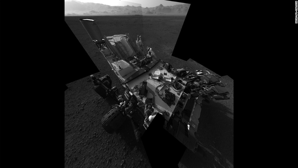 An updated self-portrait of the Mars rover Curiosity, showing more of the rover&#39;s deck. This image is a mosiac compiled from images taken from the navigation camera. The wall of &quot;Gale Crater,&quot; the rover&#39;s landing site, can be seen at the top of the image.