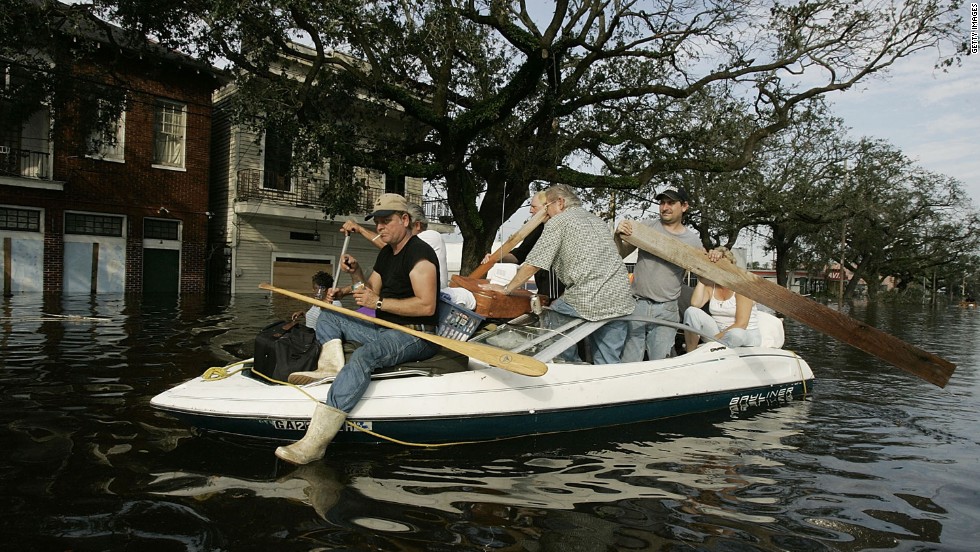 People try to get to higher ground as water rises on August 30, 2005, in New Orleans.