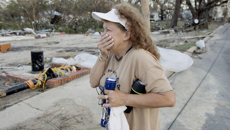 A woman cries after returning to her house and business, destroyed by Hurricane Katrina, on August 30, 2005, in Biloxi, Mississippi. 