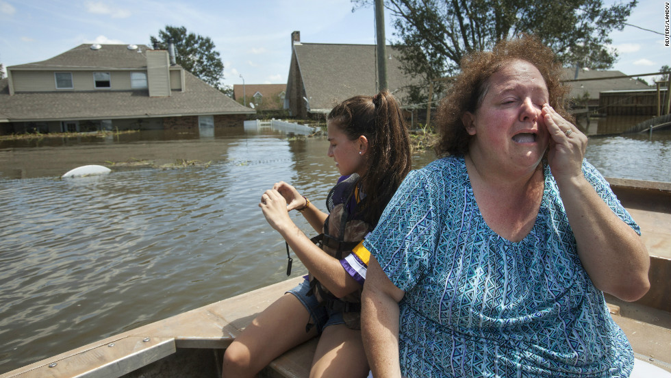 Plaquemines Parish resident Angela Serpas reacts after seeing her flooded home for the first time following Hurricane Isaac, as her daughter Lainy takes pictures, in Braithwaite, Louisiana, on Saturday, September 1.