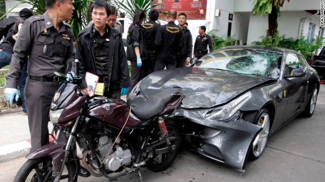 Thai police officers inspect a Ferrari owned by Vorayud Yoovidhya in Bangkok, in September 2012.