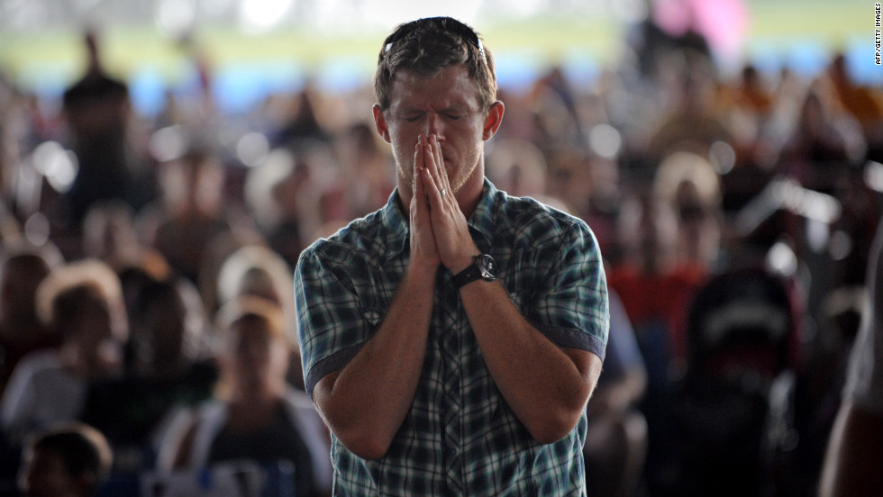 A man prays during a public prayer service at the Verizon Wireless Amphitheatre on Sunday, September 2, ahead of the convention.