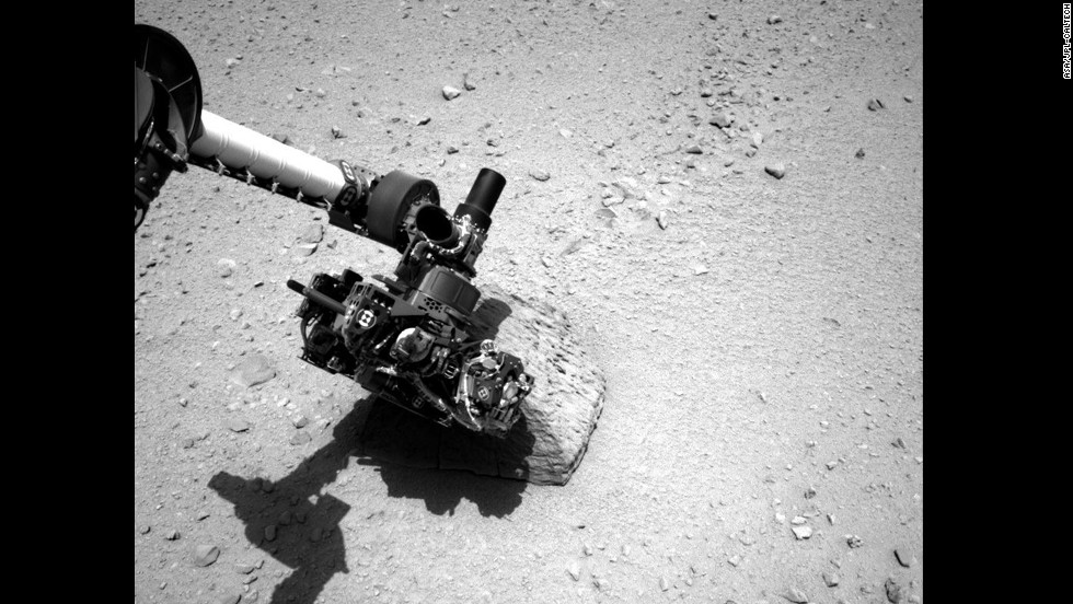 This image shows the robotic arm of NASA&#39;s Mars rover Curiosity with the first rock touched by an instrument on the arm. The photo was taken by the rover&#39;s right navigation camera.