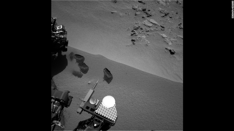 Three &quot;bite marks&quot; made by the rover&#39;s scoop can be seen in the soil on Mars surface on October 15, 2012. 