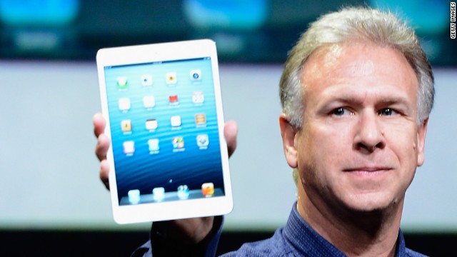 Apple marketing chief Phil Schiller holds up an iPad Mini, the company's newest gadget. Pre-orders start Friday.