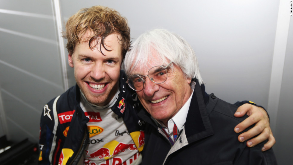 Vettel celebrates with Formule One supremo Bernie Ecclestone following his title win in Brazil.