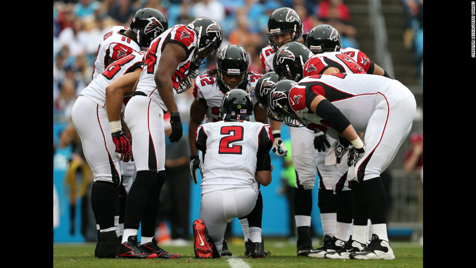 Atlanta Falcons quarterback Matt Ryan calls a play in the huddle against the Carolina Panthers at Bank of America Stadium on Sunday in Charlotte, North Carolina.
