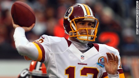 Quarterback Kirk Cousins of the Washington Redskins throws a pass as he is pressured by defensive lineman Juqua Parker of the Cleveland Browns at Cleveland Browns Stadium on Sunday, December 16, in Cleveland, Ohio.