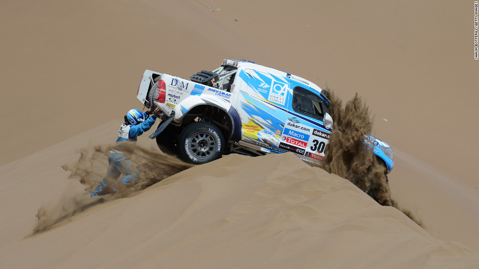 Lucio Alvarez and co-driver Ronnie Graue of Team Toyota try to move their stranded truck during the sixth stage from Arica to Calama, Chile, on Thursday, January 10.