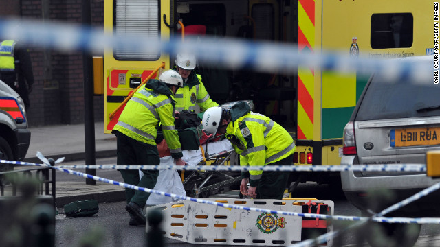 Members of the emergency services load equipment into an ambulance near the scene of a helicopter crash in central London on January 16, 2013.