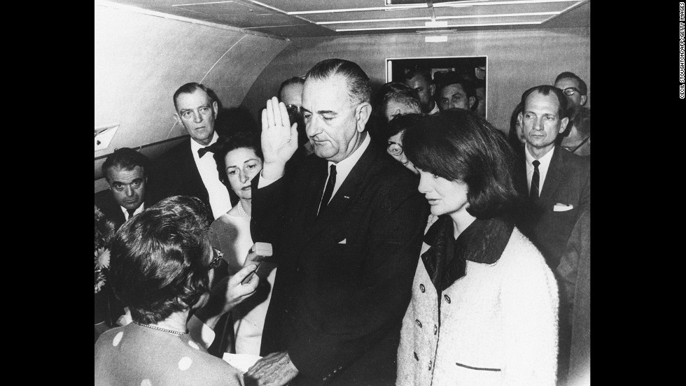 Lyndon B. Johnson takes the oath of office aboard Air Force One after the assassination of John F. Kennedy in November 1963. Standing on the right is Kennedy&#39;s widow, Jackie.