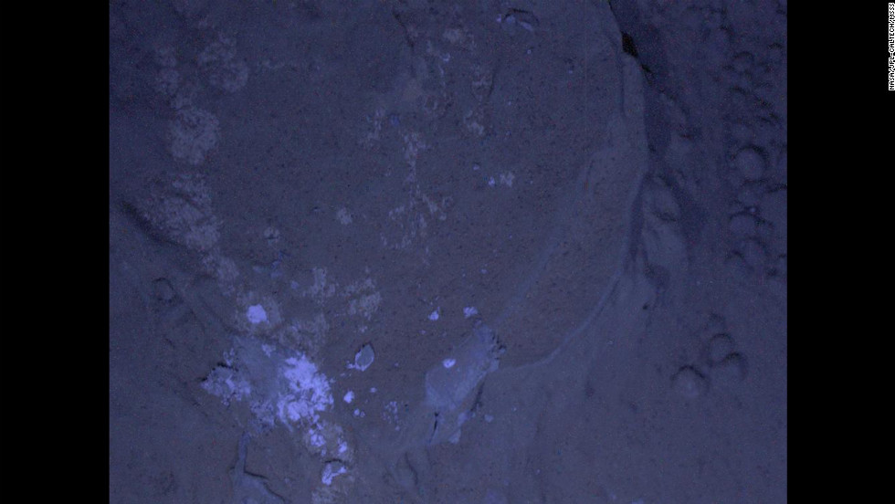 Curiosity&#39;s first set of nighttime photos include this image of Martian rock illuminated by ultraviolet lights. Curiosity used the camera on its robotic arm, the Mars Hand Lens Imager, to capture the images on January 22, 2013.