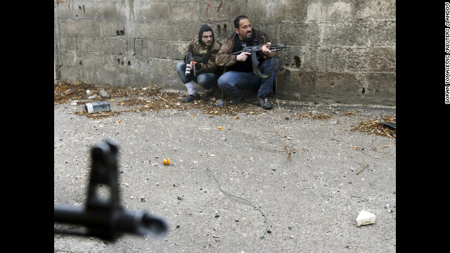 Image #: 21013203    Free Syrian Army fighters take position just before they were hit by Syrian Army sniper fire during heavy fighting in the Ain Tarma neighbourhood of Damascus January 30, 2013. The fighter on the right died soon after, while his comrade was wounded. REUTERS/Goran Tomasevic (SYRIA - Tags: CIVIL UNREST POLITICS CONFLICT)       REUTERS /GORAN TOMASEVIC /LANDOV
