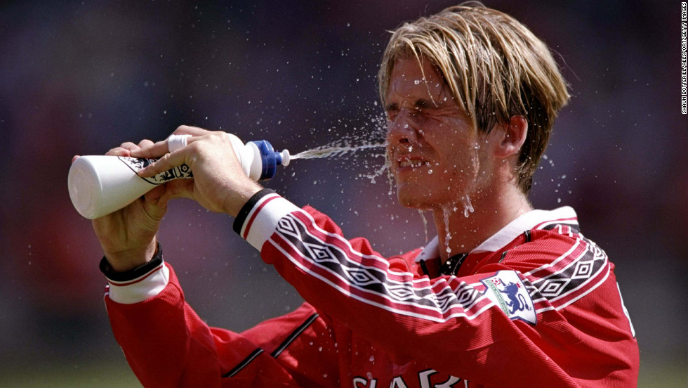 As a player on Manchester United, Beckham cools down during the FA Charity Shield match against Arsenal in 1998.