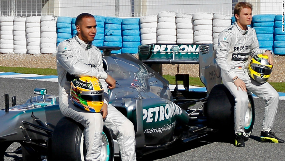 Former McLaren star Lewis Hamilton, left, and new teammate Nico Rosberg pose with the new Mercedes W04 on February 4.