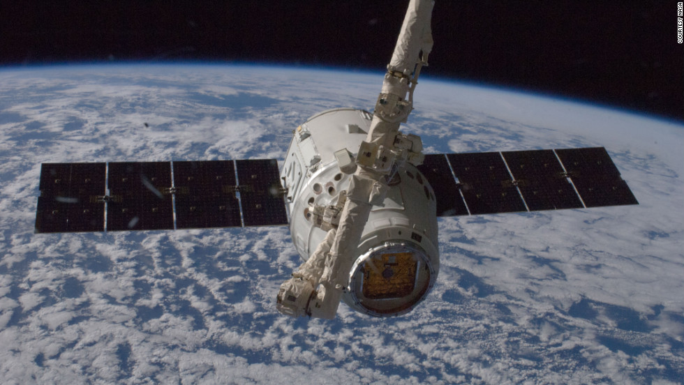 The unmanned SpaceX Dragon spacecraft connects to the space station in May 2012. It was the first private spacecraft to successfully reach an orbiting space station.