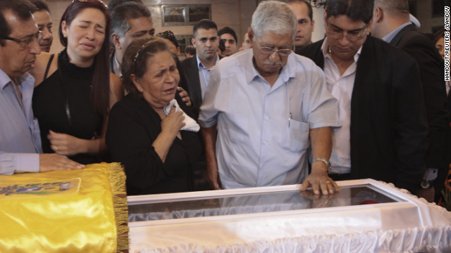  Relatives of Venezuela's late President Hugo Chavez, his brother Adan (2nd L), his mother Elena Frias (4th L) and his father Hugo (2nd R), cry as they view his coffin during a wake at the military academy in Caracas March 7, 2013, in this picture provided by the Miraflores Palace. Chavez will be embalmed and put on display "for eternity" at a military museum after a state funeral and an extended period of lying in state, acting President Nicolas Maduro said on Thursday. REUTERS/Miraflores Palace/Handout (VENEZUELA - Tags: POLITICS OBITUARY) REUTERS /HANDOUT /LANDOV   Photographers/Source: HANDOUT/Reuters /Landov  