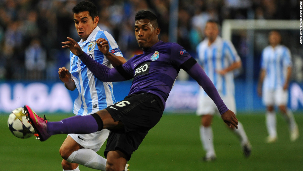 Malaga&#39;s Javier Saviola goes up against Porto&#39;s Alex Sandro with the Spanish club aiming to overturn a one-goal deficit from the first leg.  