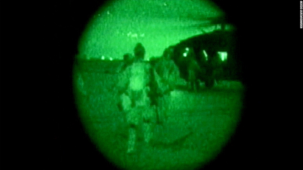 A night-vision image shows U.S. military personnel carrying Pfc. Jessica Lynch off a helicopter on April 1, 2003, at an undisclosed location in Iraq. She had been missing since March 23, when she and members of her unit were ambushed by Iraqi forces.