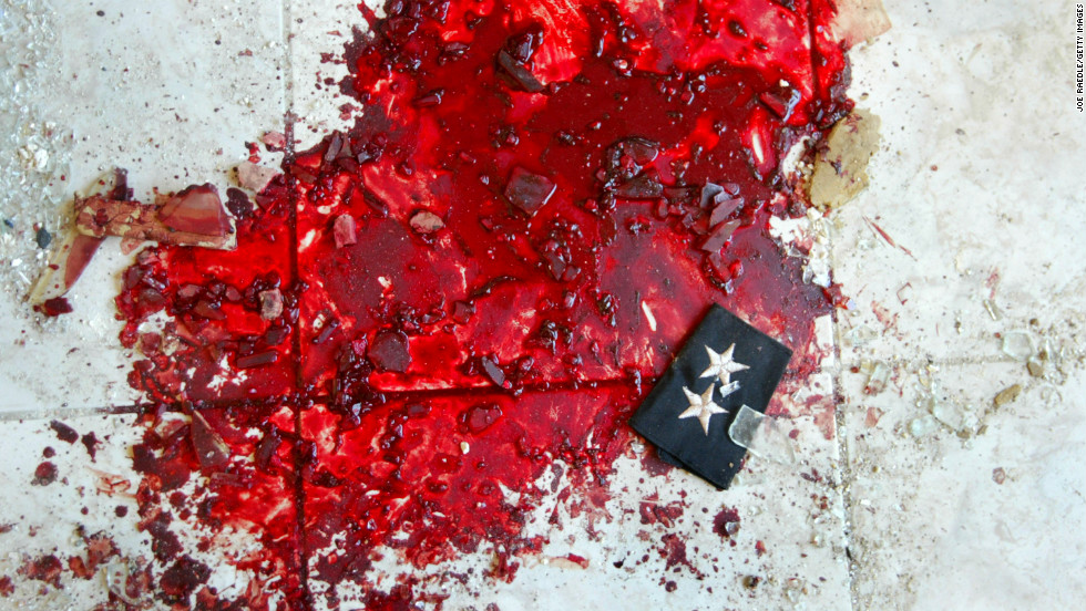 An Iraqi police lieutenant&#39;s stars lie in a puddle of blood after a car bombing that targeted a police station in Baquba on November 22, 2003.